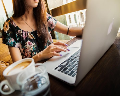 Woman working on laptop with soft warm lighting in a modern Mexican apartment