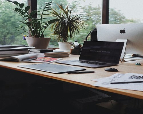 Well lit home office desk setup with natural sunlight
